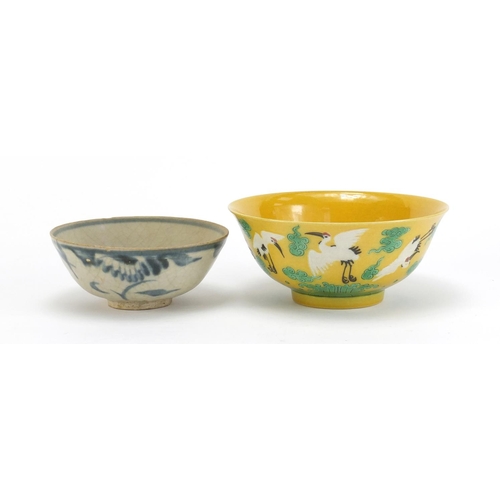 834 - Two Chinese porcelain bowls including a yellow ground example, hand painted with cranes amongst clou... 