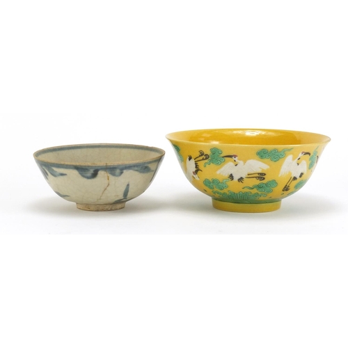 834 - Two Chinese porcelain bowls including a yellow ground example, hand painted with cranes amongst clou... 