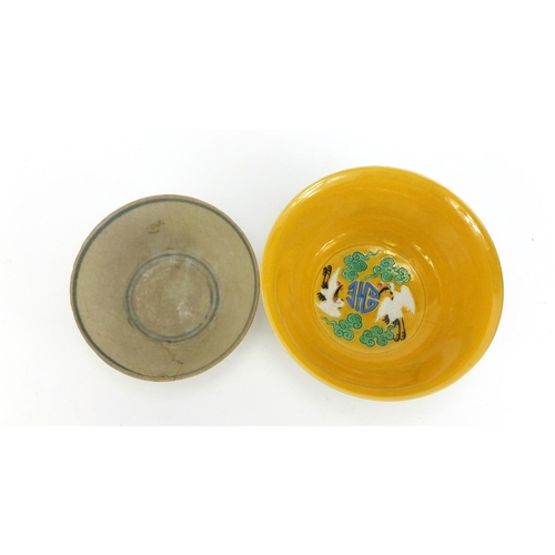 834 - Two Chinese porcelain bowls including a yellow ground example, hand painted with cranes amongst clou... 