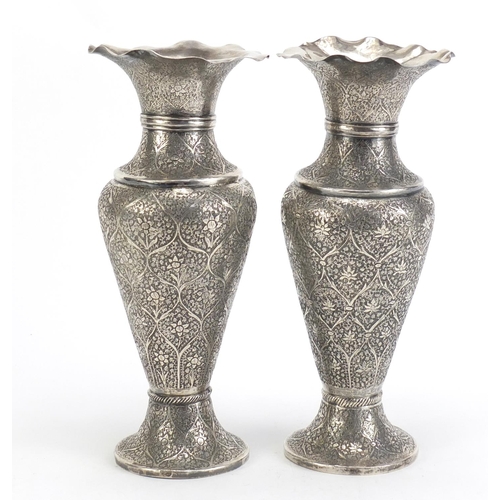 515 - Pair of Persian silver vases profusely engraved with flowers, 22cm high, 480.0g