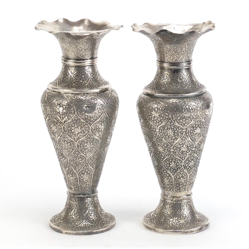 515 - Pair of Persian silver vases profusely engraved with flowers, 22cm high, 480.0g