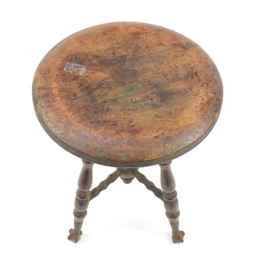 345 - Antique American revolving piano stool on wrought iron, glass claw and ball feet, 48cm high