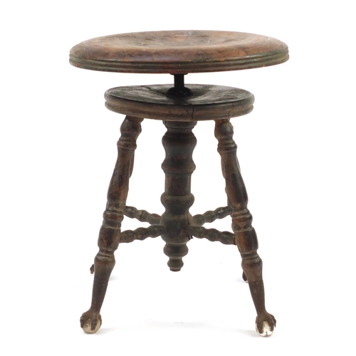 345 - Antique American revolving piano stool on wrought iron, glass claw and ball feet, 48cm high