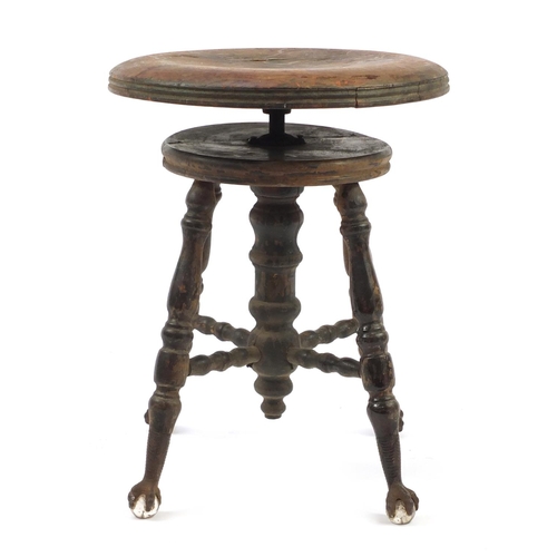 345 - Antique American revolving piano stool on wrought iron, glass claw and ball feet, 48cm high