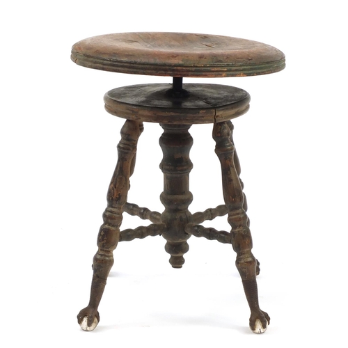 345 - Antique American revolving piano stool on wrought iron, glass claw and ball feet, 48cm high