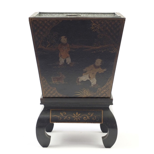 103 - Chinese black lacquered planter with liner on stand, hand painted with a panel of children playing, ... 