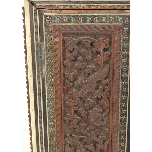 528 - Indian Vizagapatam upright travelling chest, the front panels carved with animals and flowers, 26cm ... 