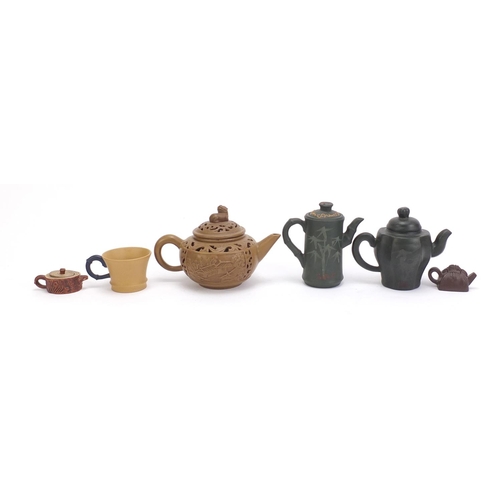 490 - Chinese Yixing teracotta comprising three teapots, two miniature teapots and a cup, the five teapots... 