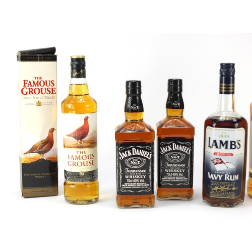 73 - Seven bottles of whiskey and rum including 1L Bells, two bottles of Jack Daniels, The Famous Grouse ... 