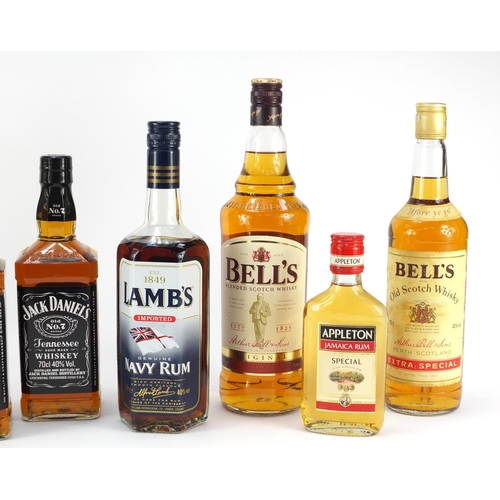 73 - Seven bottles of whiskey and rum including 1L Bells, two bottles of Jack Daniels, The Famous Grouse ... 