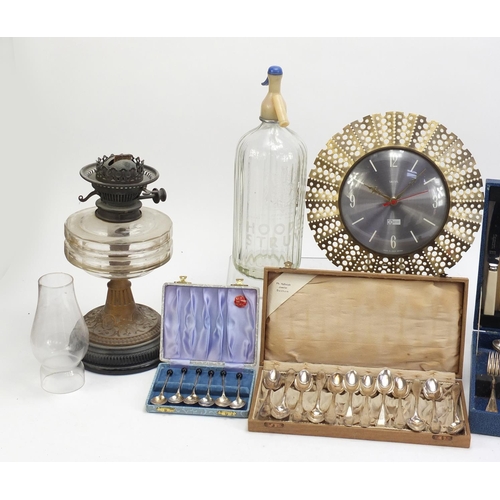 1523 - Sundry items including an oil lamp, advertising soda syphon, inlaid box, Smith's clock and cutlery s... 