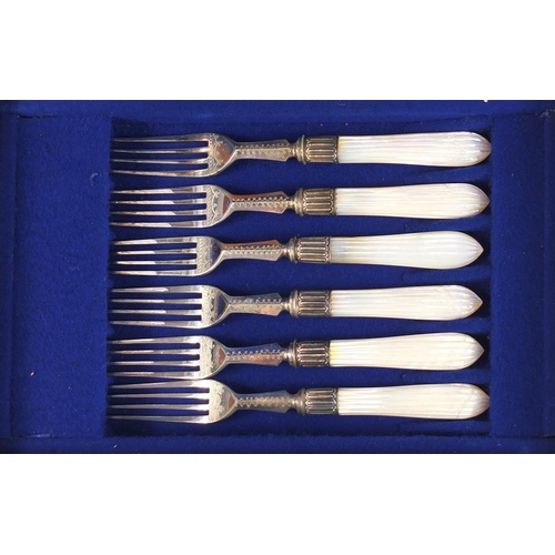 822 - Set of six silver plated cake knives and forks with mother of pearl handles, housed in a fitted waln... 