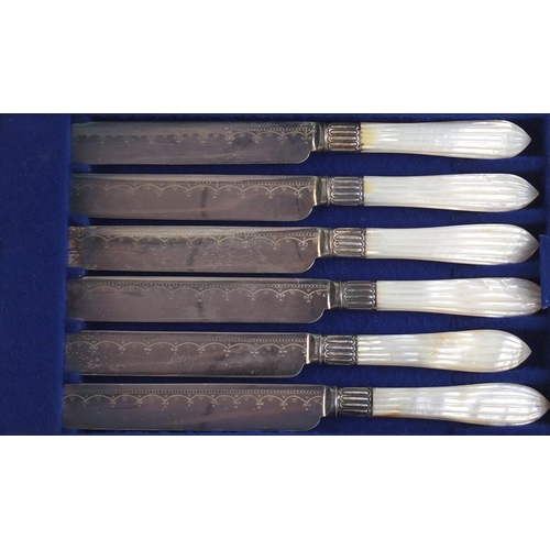 822 - Set of six silver plated cake knives and forks with mother of pearl handles, housed in a fitted waln... 