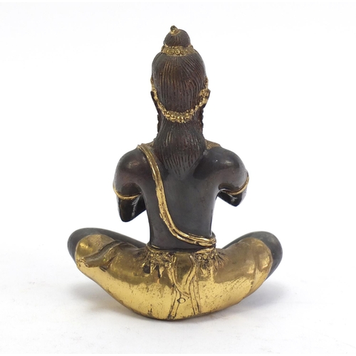 888 - Asian partially gilt bronze figure of a female playing a flute, 15cm high