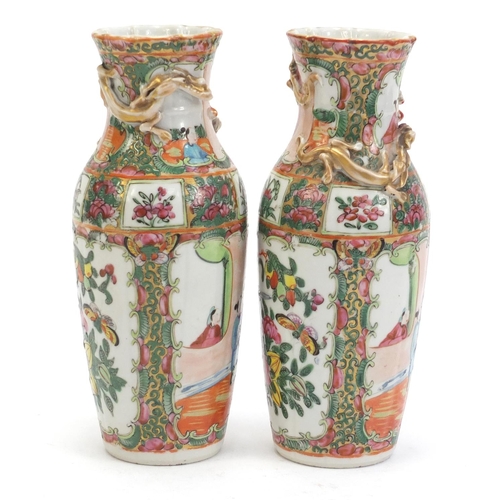 304 - Pair of Chinese Canton porcelain vases with relief dragons, each hand painted in the famile rose pal... 