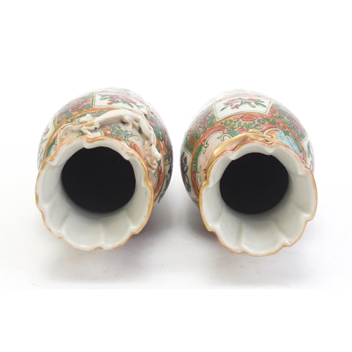 304 - Pair of Chinese Canton porcelain vases with relief dragons, each hand painted in the famile rose pal... 