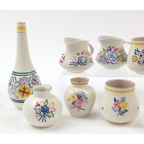 1524 - Poole Pottery including vases, each hand painted with flowers, the largest 26cm high