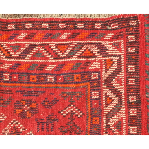 1598 - Rectangular Persian rug having an all over geometric floral design onto a red ground, 123cm x 80cm