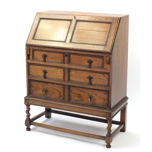 1603 - Oak bureau with a fall enclosing a fitted interior above three drawers, 101cm H x 76cm W x 38cm D