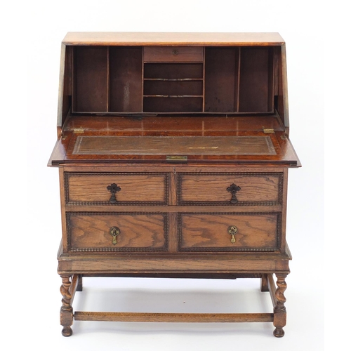 1603 - Oak bureau with a fall enclosing a fitted interior above three drawers, 101cm H x 76cm W x 38cm D