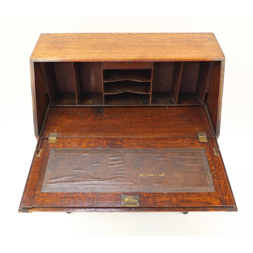 1603 - Oak bureau with a fall enclosing a fitted interior above three drawers, 101cm H x 76cm W x 38cm D