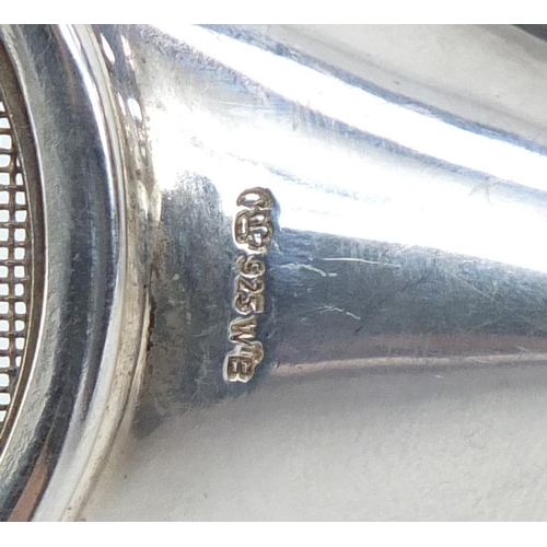 459 - Modernist Continental silver tea strainer on stand, and teak basket with 800 grade silver swing hand... 