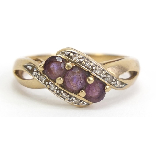 1110 - 9ct gold amethyst and diamond crossover ring, size P, 2.8g