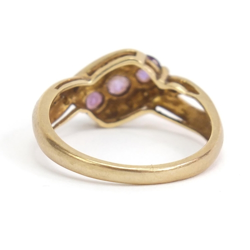 1110 - 9ct gold amethyst and diamond crossover ring, size P, 2.8g