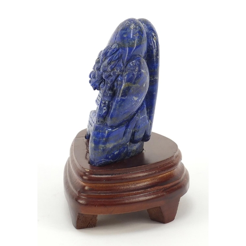 230 - Chinese lapis lazuli fragment carved with buildings amongst mountains raised on a wood stand, the ca... 