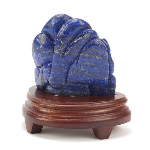 230 - Chinese lapis lazuli fragment carved with buildings amongst mountains raised on a wood stand, the ca... 