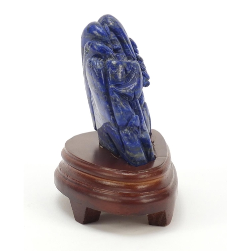 230 - Chinese lapis lazuli fragment carved with buildings amongst mountains raised on a wood stand, the ca... 