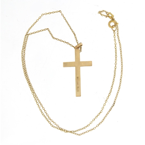 904 - 9ct gold cross pendant, 3.2cm in length, 1.0g on a gold plated necklace