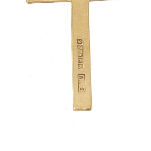 904 - 9ct gold cross pendant, 3.2cm in length, 1.0g on a gold plated necklace