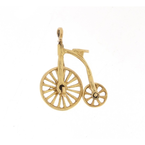 1058 - 9ct gold penny farthing charm, 2.2cm in length, 2.5g