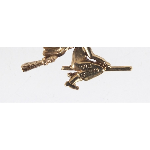 1102 - 9ct gold witch on a broomstick charm, 2.3cm in length, 2.3g