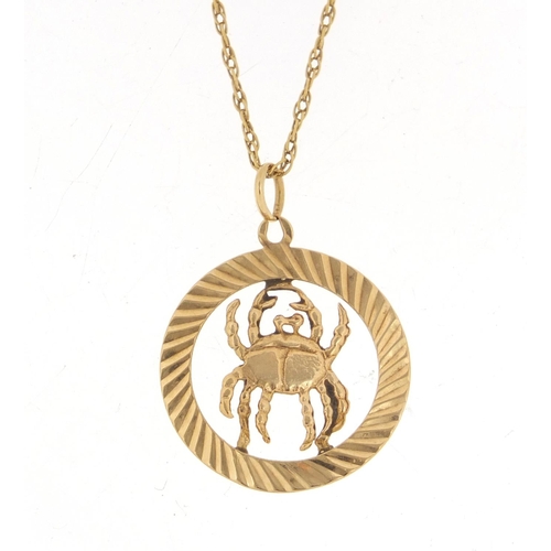 791 - 9ct gold zodiac Cancer pendant, 2.5cm in diameter, 2.1g, on an unmarked gold necklace, 2.5g