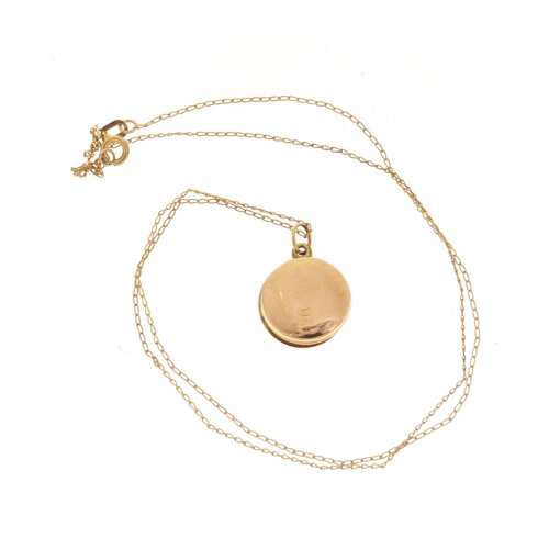 964 - 9ct gold circular locket on a 9ct gold necklace, the locket 1.2cm in diameter, 1.5g