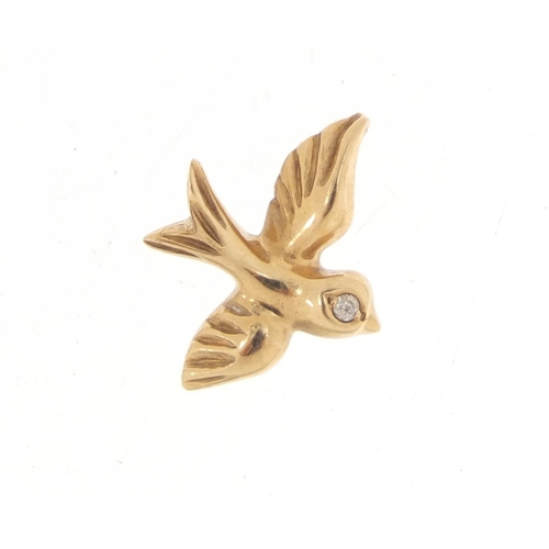 1014 - 9ct gold bird pendant, set with a diamond, 1.6cm in length, 1.7g