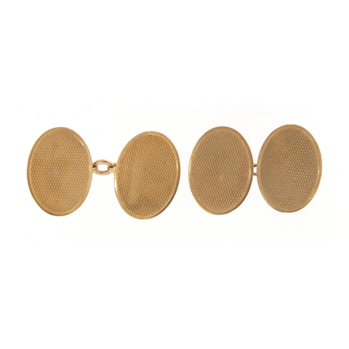 1109 - Pair of 9ct gold cufflinks with engine turned decoration, housed in a James Walker box, 2cm in lengt... 