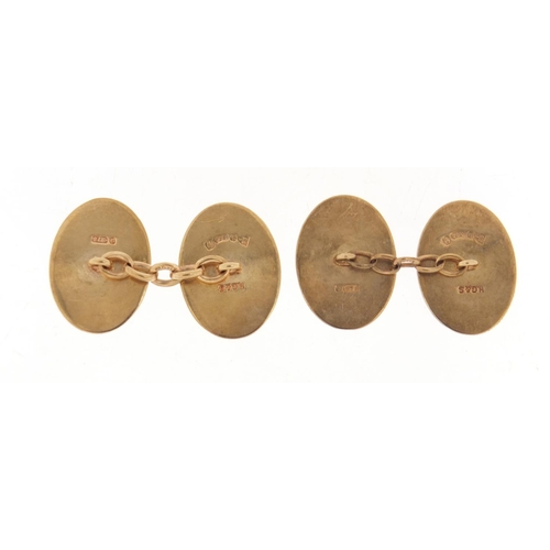 1109 - Pair of 9ct gold cufflinks with engine turned decoration, housed in a James Walker box, 2cm in lengt... 