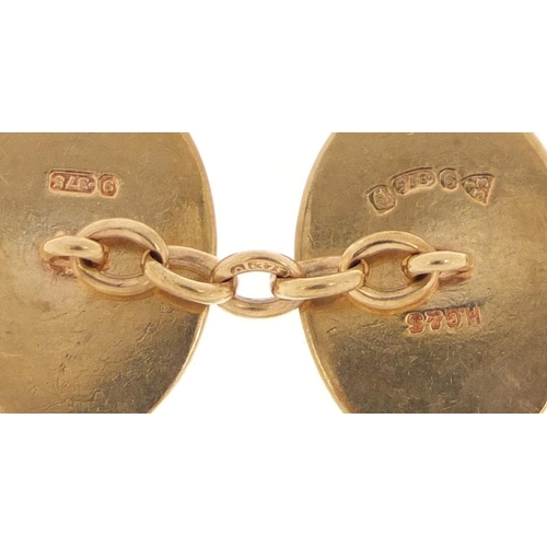 1109 - Pair of 9ct gold cufflinks with engine turned decoration, housed in a James Walker box, 2cm in lengt... 