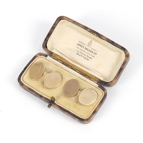 1109 - Pair of 9ct gold cufflinks with engine turned decoration, housed in a James Walker box, 2cm in lengt... 