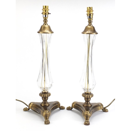 886 - Pair of ornate brass table lamps with paw feet and cut glass columns, each 49cm high