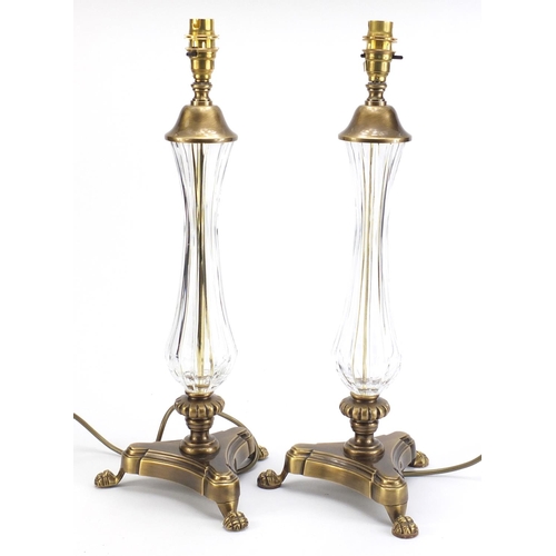 886 - Pair of ornate brass table lamps with paw feet and cut glass columns, each 49cm high