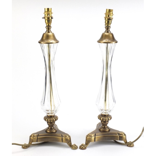 886 - Pair of ornate brass table lamps with paw feet and cut glass columns, each 49cm high