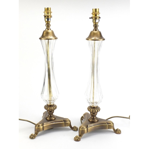 886 - Pair of ornate brass table lamps with paw feet and cut glass columns, each 49cm high