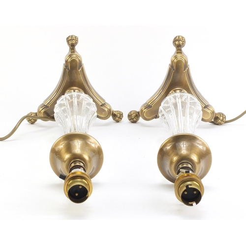 886 - Pair of ornate brass table lamps with paw feet and cut glass columns, each 49cm high