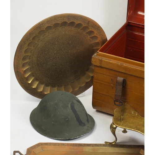 1560 - Metalware comprising a vintage trunk, brass footman, military tin helmet and two Indian trays, the l... 