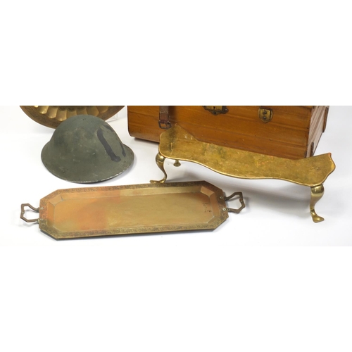 1560 - Metalware comprising a vintage trunk, brass footman, military tin helmet and two Indian trays, the l... 