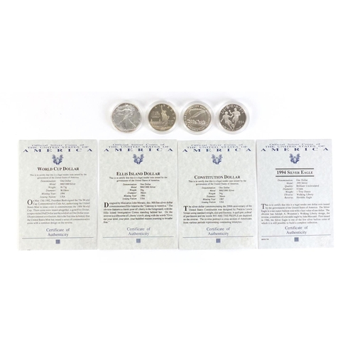 665 - Four American silver dollars with certificate of authenticity, comprising 1994 silver eagle, 1986 El... 